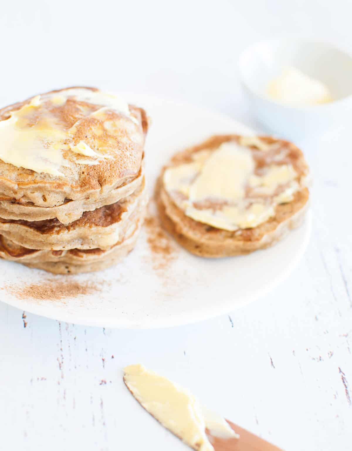 A stack of banana pikelets on a white plate