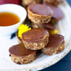 mini date sweetened caramel slice bites stacked on a plate