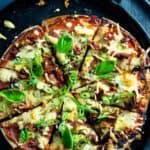 pizza on flatbread sliced into 8 pieces on a serving tray