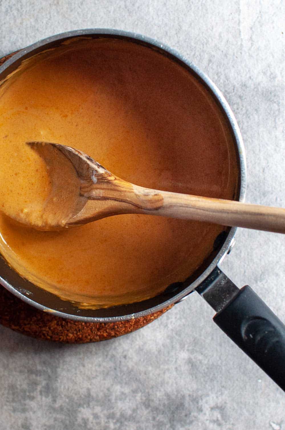 peanut sauce in a saucepan cooking on stove