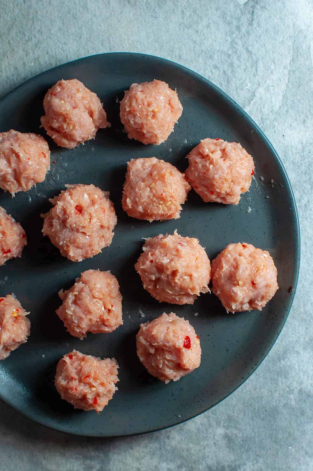 Raw chicken meatballs on a plate