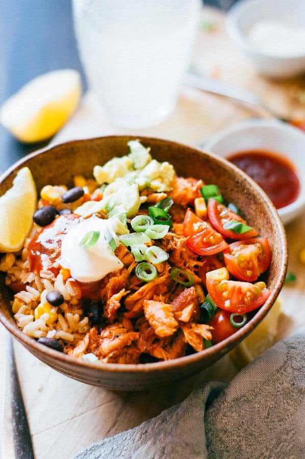 salmon burrito bowl with sour cream close up