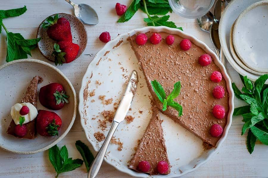 A white dish with a slice of chilli chocolate cheesecake