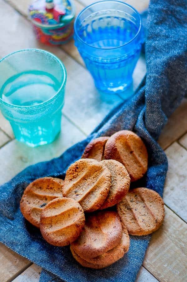 a bunch of ginger biscuits scattered on a blue tea towel