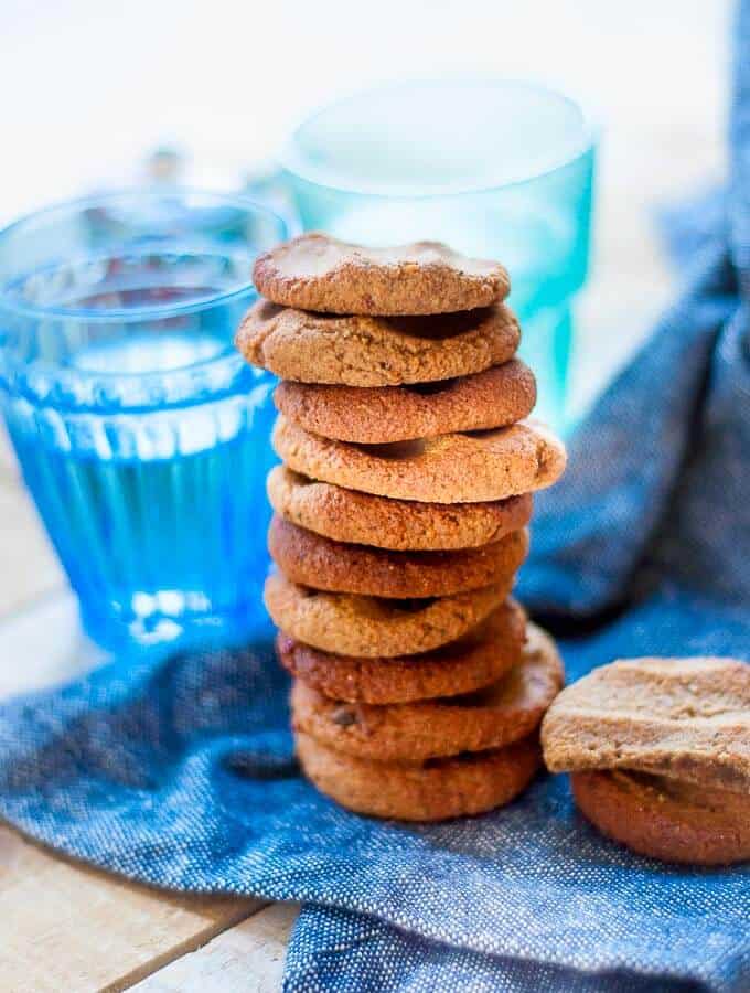 a tall stack of ginger biscuits on a blue tea towel