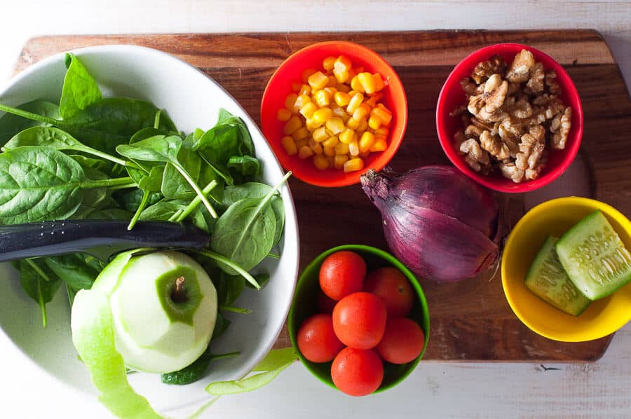 cutting board with salad ingredients