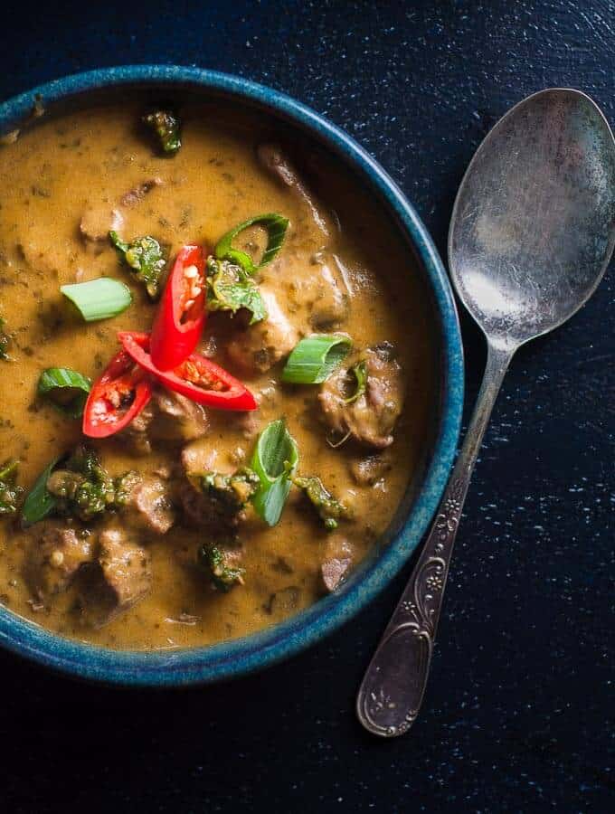 a bowl of pressure cooker beef curry with spoon