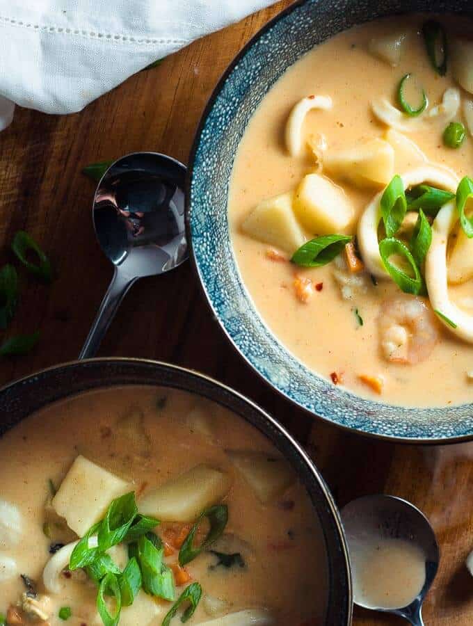 Two blue bowls of Seafood Chowder with cream cheese 