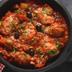 oven pan with chicken caccitore and black olives
