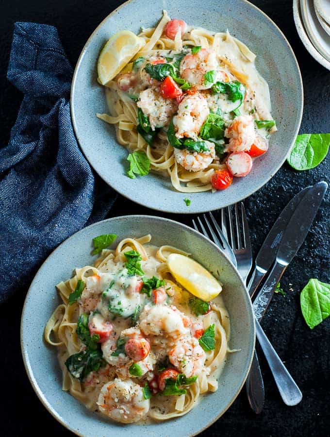 Two bowls of creamy garlic prawn fettucine