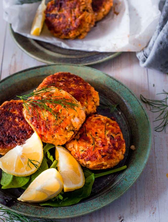 salmon fritters on a plate with lemon