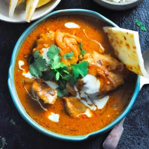 butter chicken curry in a bowl with roti