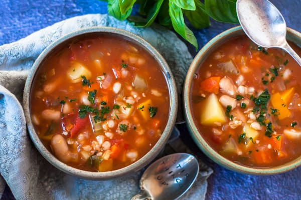 Two bowls of vegetable barley soup