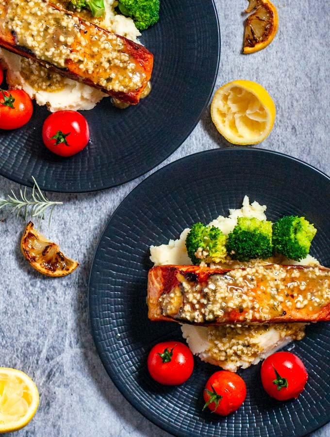 Lemon garlic butter salmon mashed potatoes on black plate