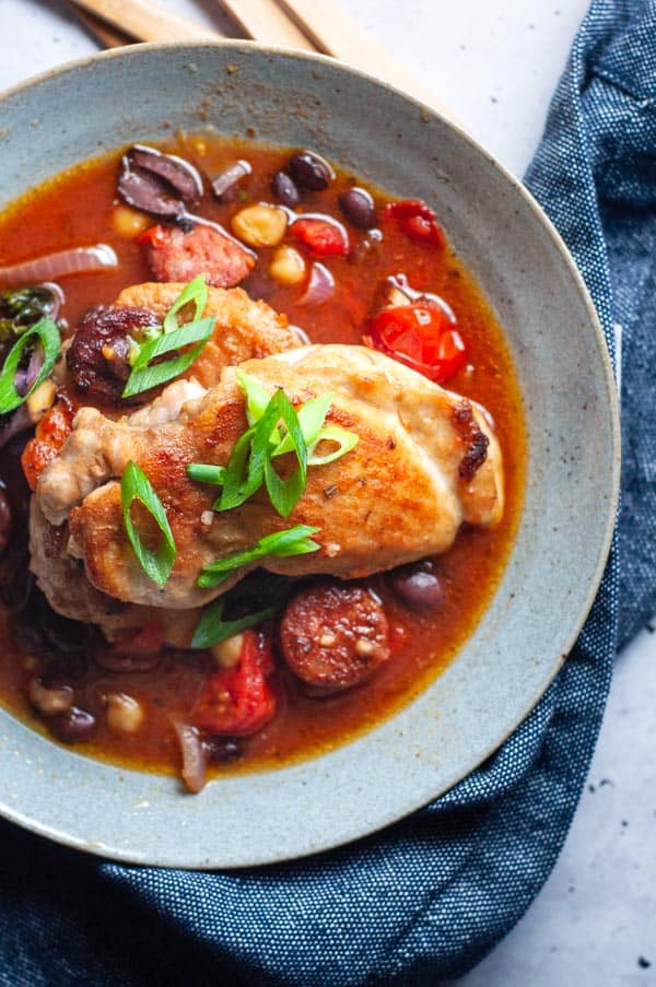 Spanish chicken tray bake in a blue bowl