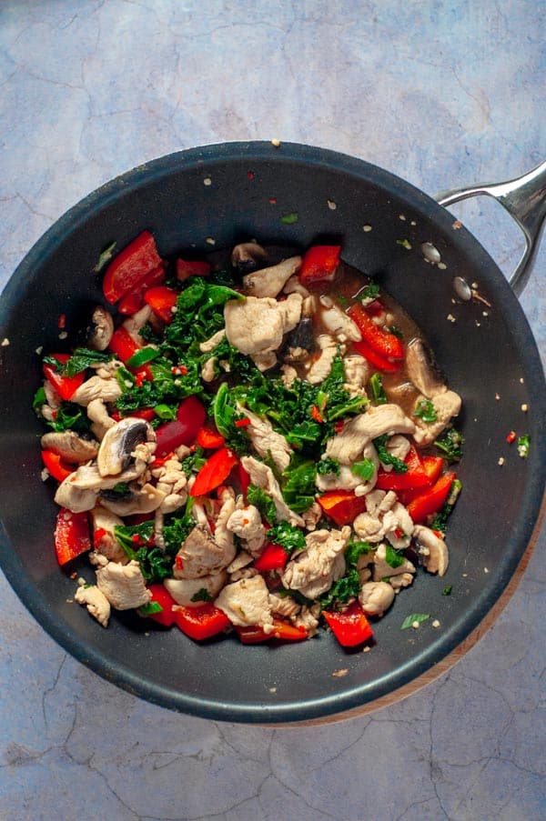 chicken kale capsicum in a wok