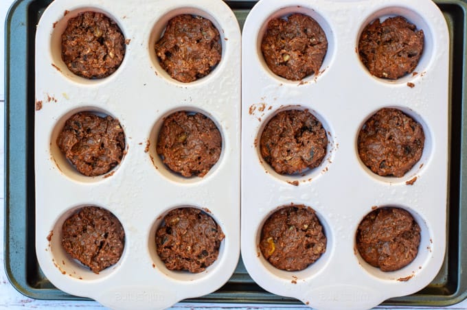 Chocolate date slice uncooked in muffin trays