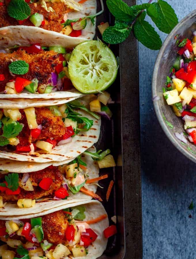 Fish tacos with pineapple salsa in a tray