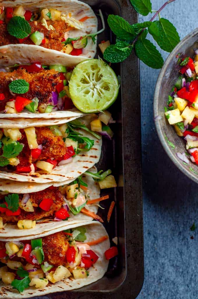 Fish tacos with pineapple salsa in a tray