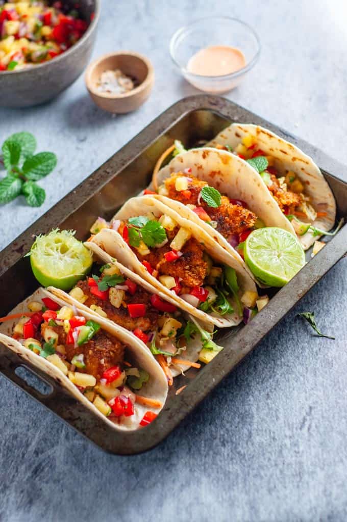 a tray of fish tacos with pineapple salsa