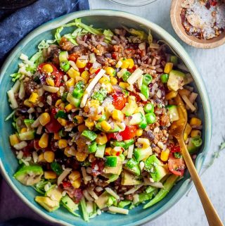 healthy burrito bowl on a table with fork