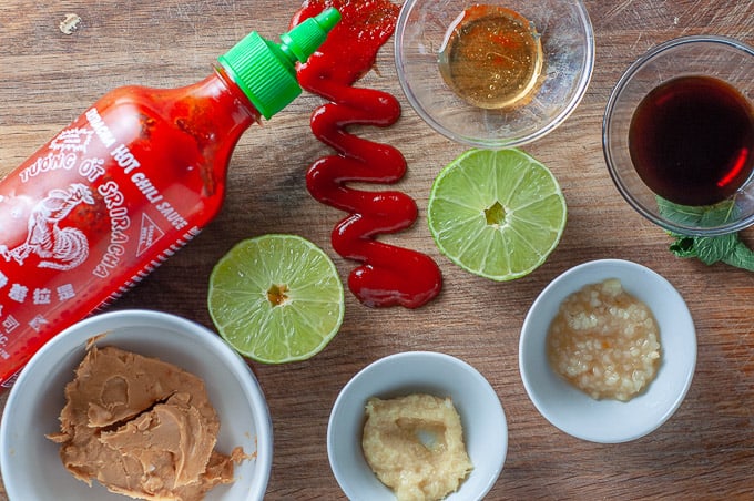 Raw Thai chicken meatball mixture with herbs in a bowl