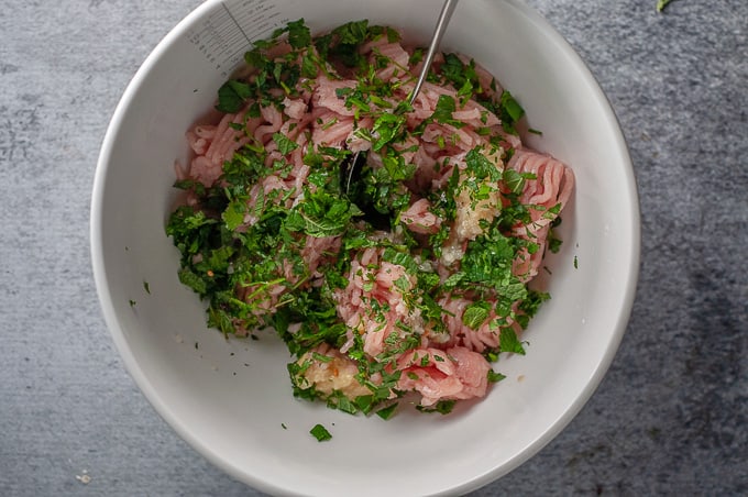 chicken mince and herbs in a bowl