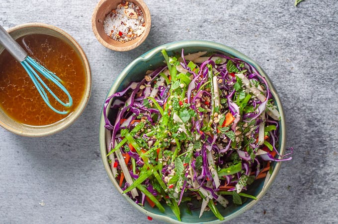 a bowl of asian slaw with dressing