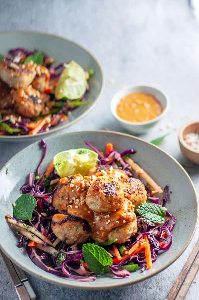 two bowls of ai chicken meatballs with peanut sauceth