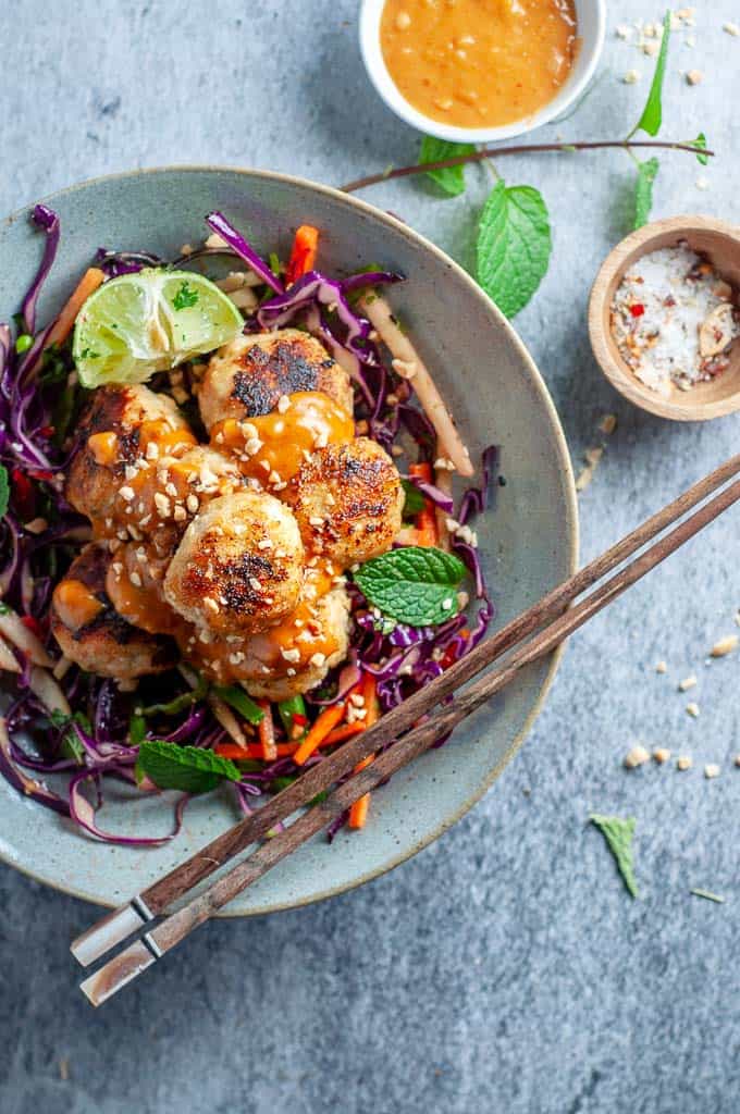 a bowl of thai chicken meaballs with chopsticks