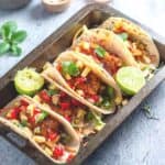5 fish tacos sitting in a serving tray