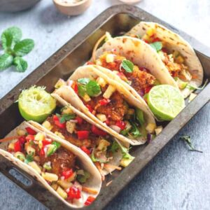 5 fish tacos sitting in a serving tray