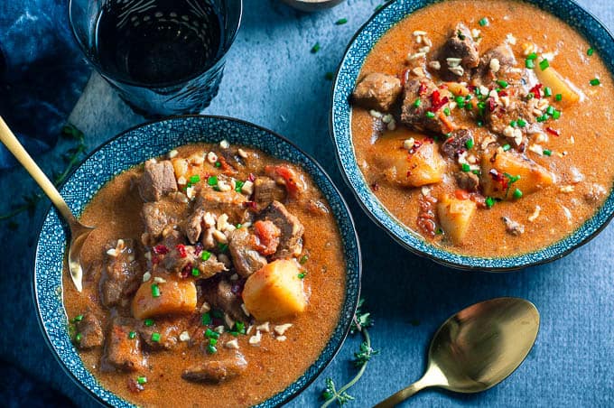 two blue bowls with pressure cooker beef rendang curry