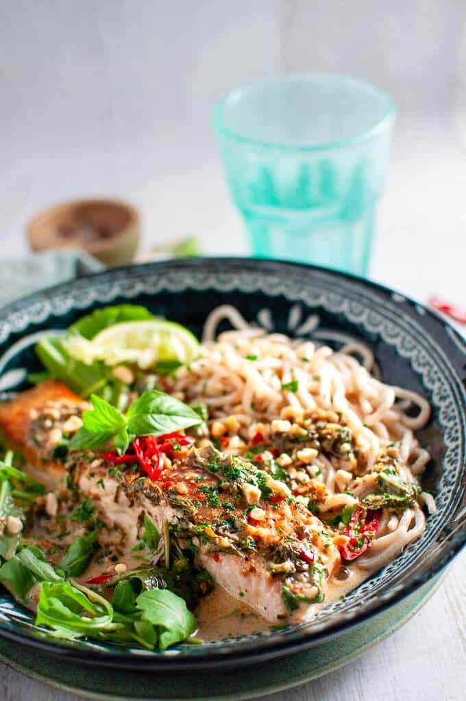 coconut lime salmon with noodles in a bowl, chilli and thai basil on top