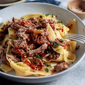 slow cooked lamb ragu with pasta in a bowl