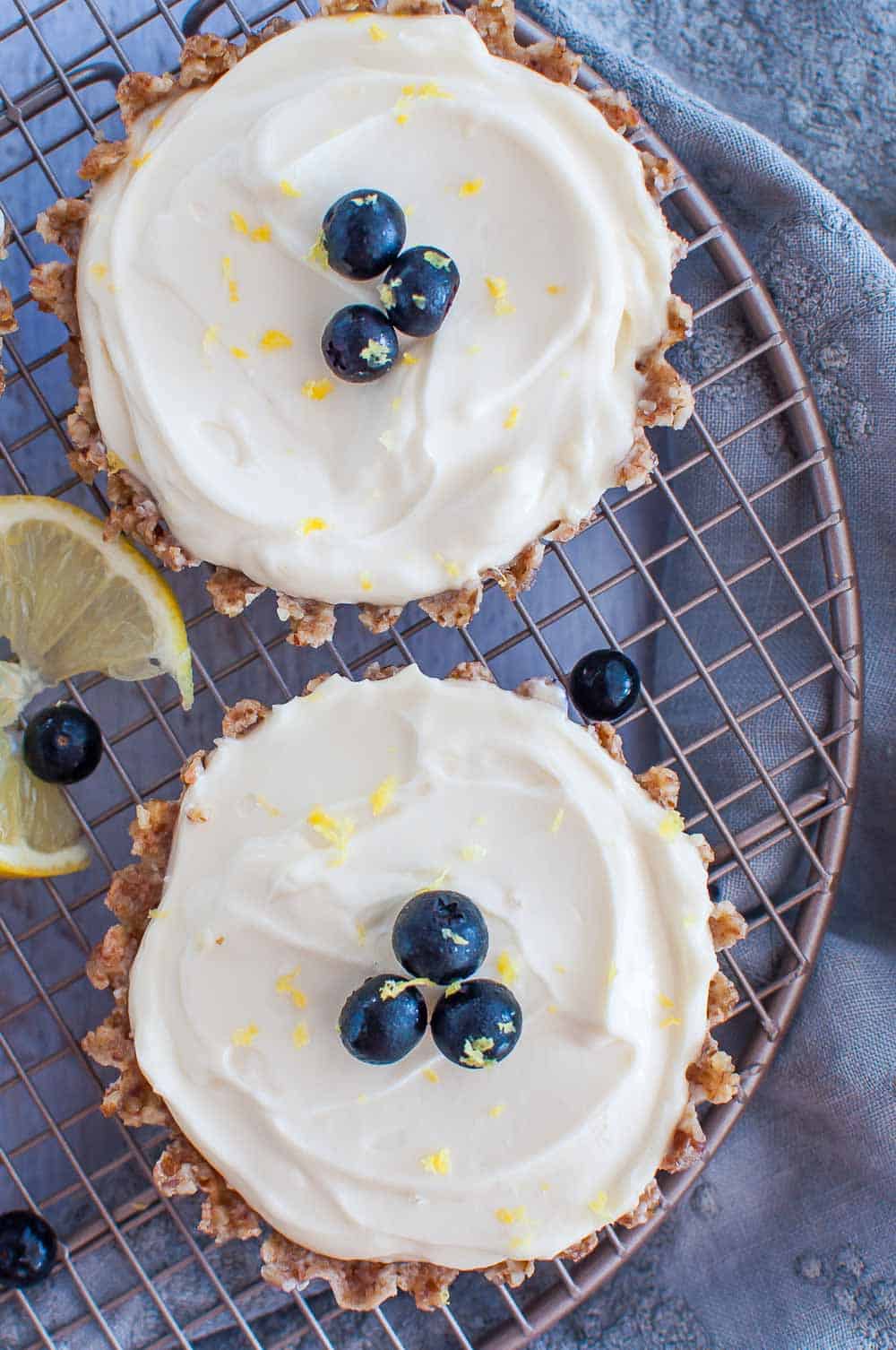 two mini lemon tarts on wire rack