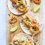 wooden board with 3 crunchy calamari tacos