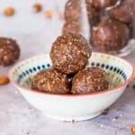 little bowl with 3 stacked almond butter bliss balls