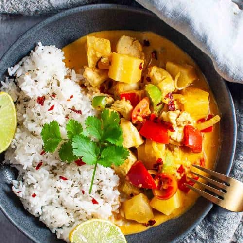 A bowl of pineapple curry chicken and rice