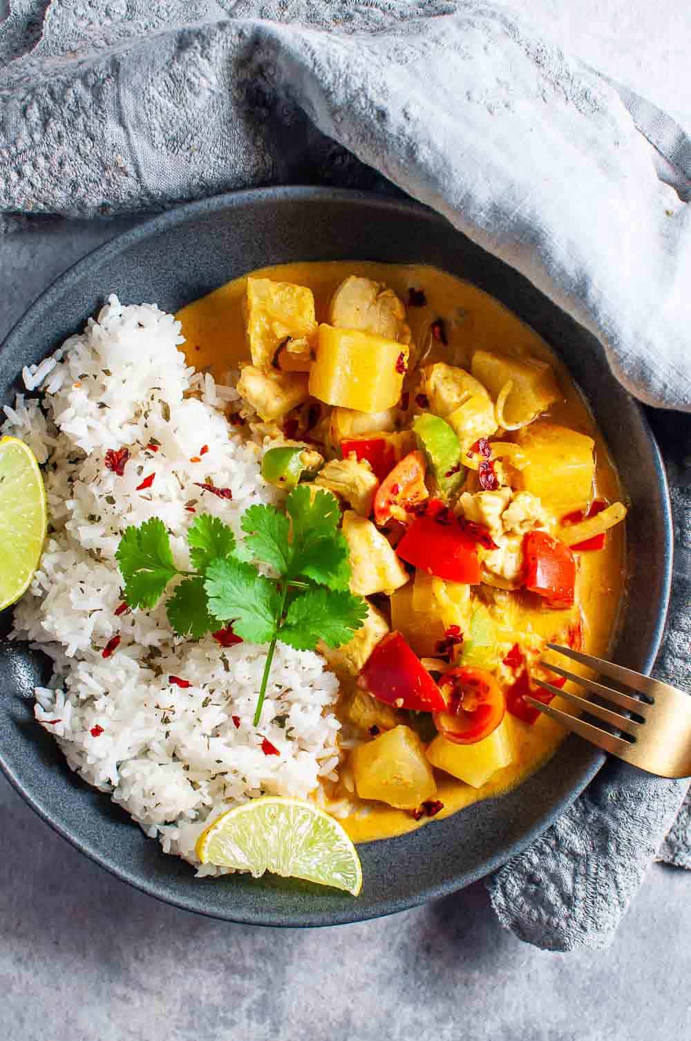 A bowl of pineapple curry chicken and rice