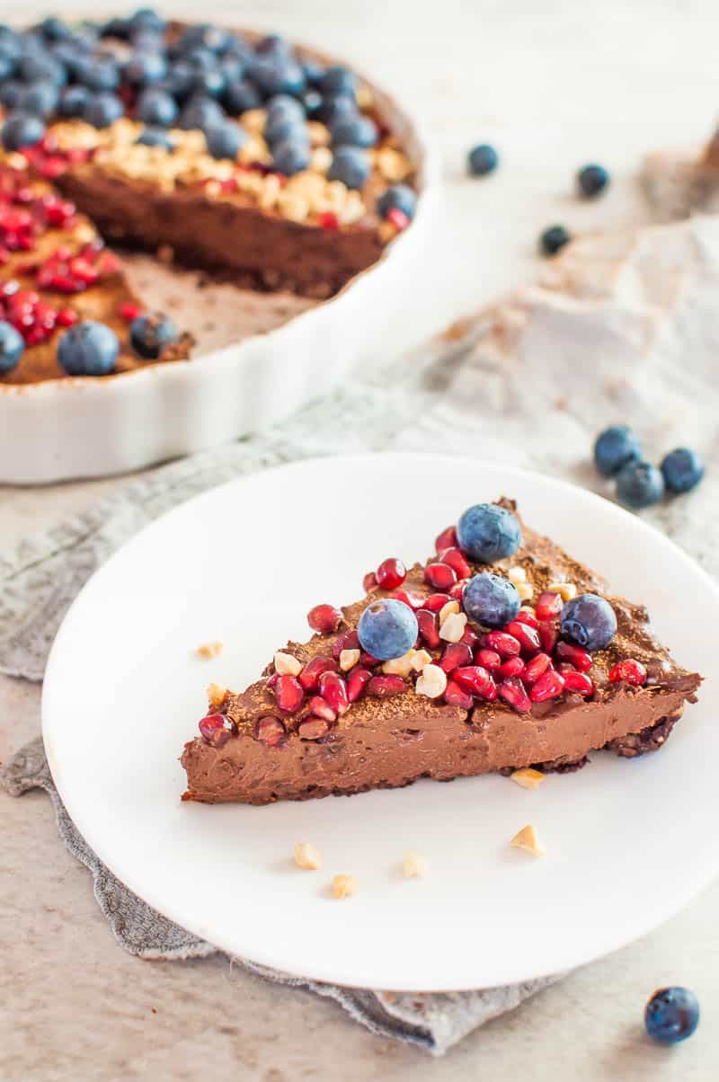 a slice of no bake chocolate tart with berries