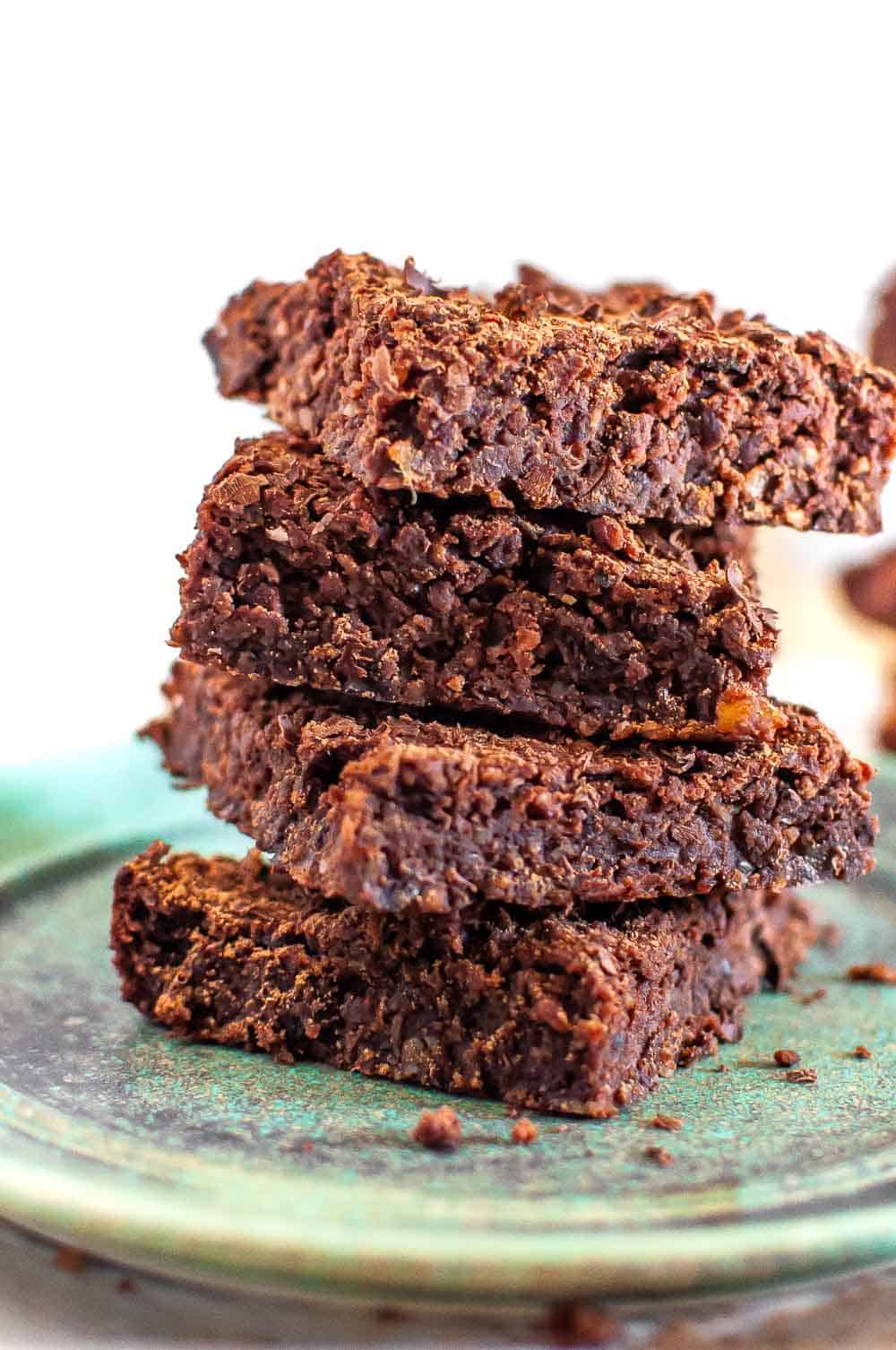 a stack of three dairy free brownies on a green plate