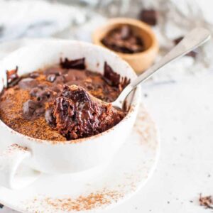 chocolate in a white cup with a spoon digging in