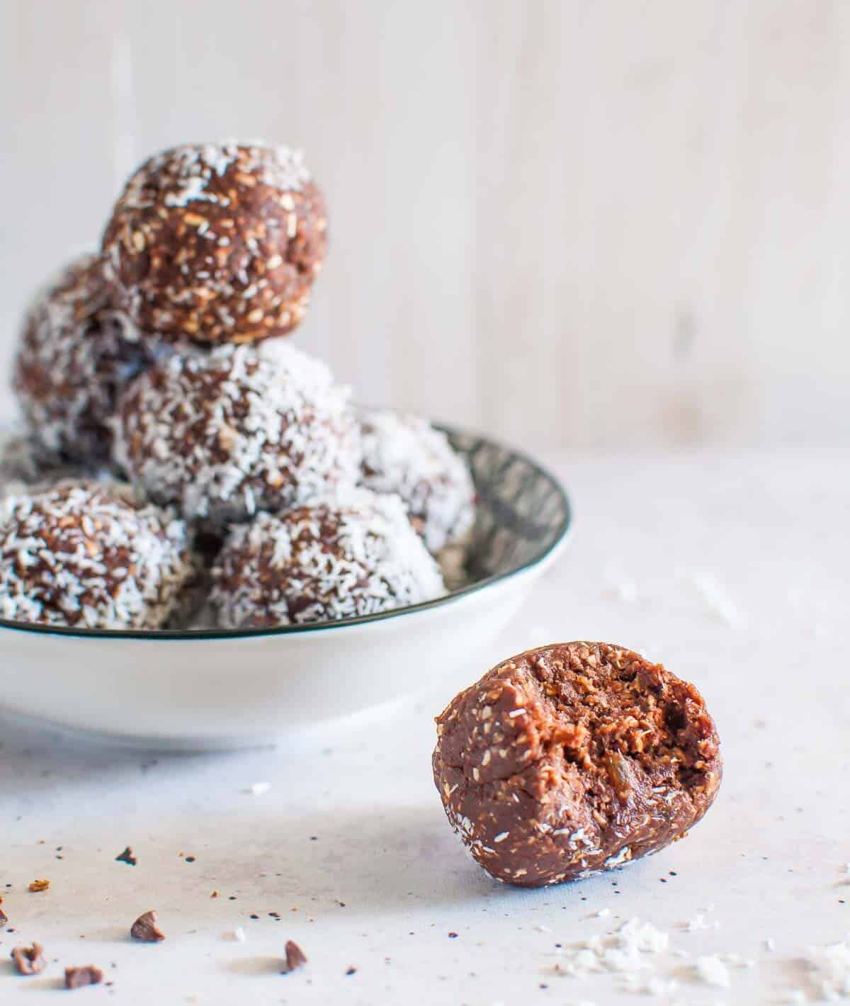 a Chocolate Coconut Date Ball wiith a bite out