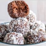 chocolate coconut date balls stacked in a bowl