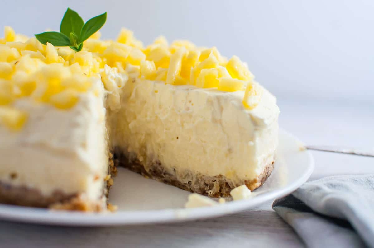 pineapple tart on a white plate with slice out