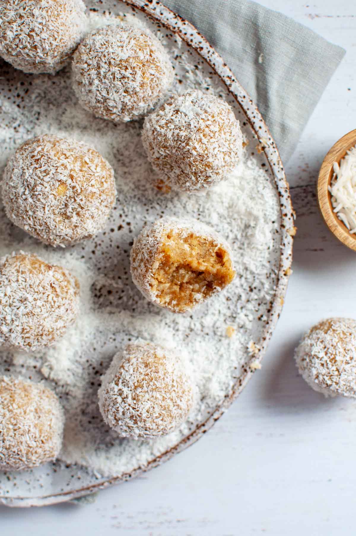 a plate of lemon energy balls with coconut