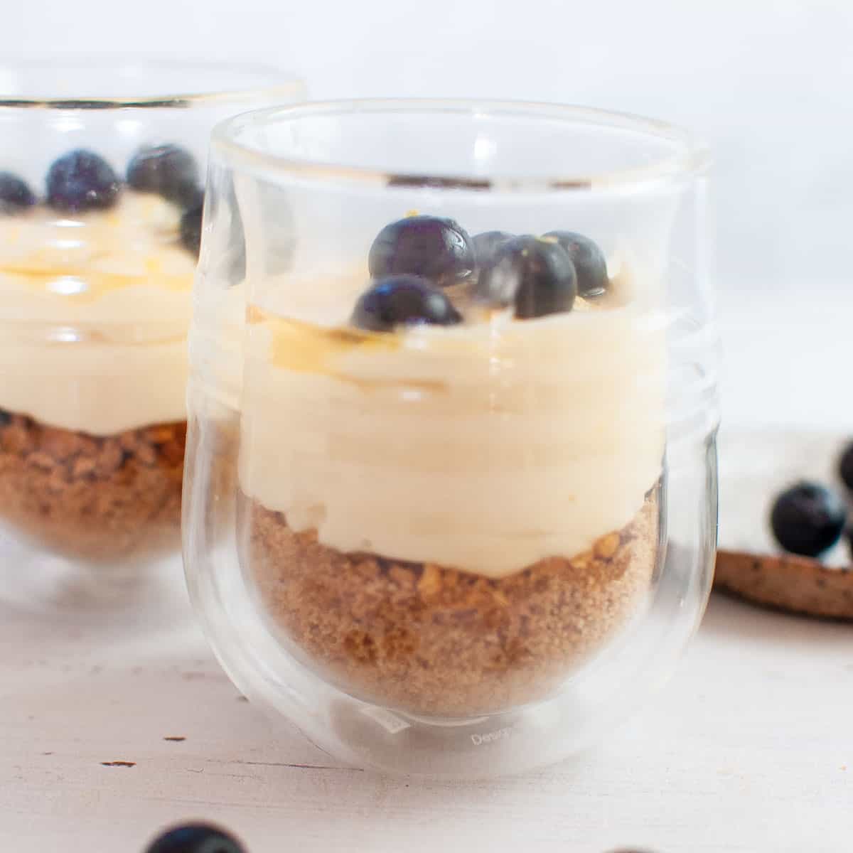 Finished cheesecake dessert cups with blueberries on top