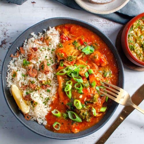 a bowl of slow cooked spicy chicken with a fork in