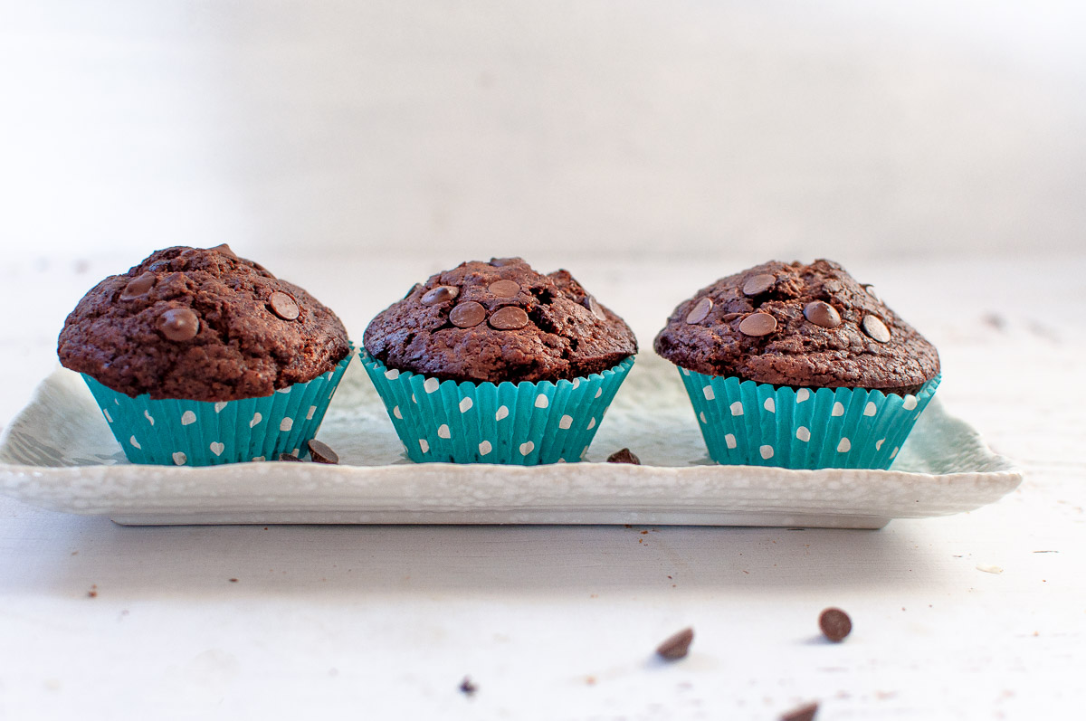 3 muffins in paper cases on a plate